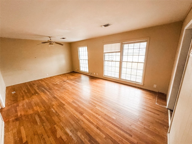 spare room featuring ceiling fan and light hardwood / wood-style floors