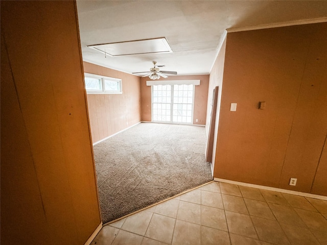 carpeted spare room with ornamental molding and ceiling fan