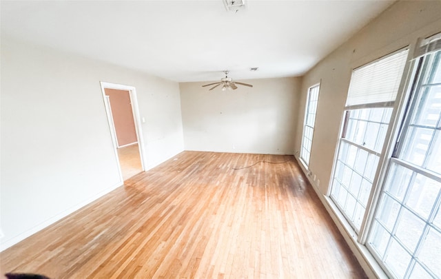 spare room with ceiling fan and light wood-type flooring