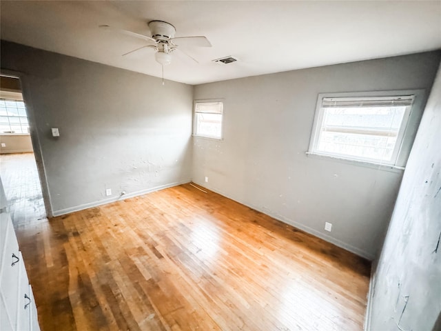 empty room featuring ceiling fan and light wood-type flooring