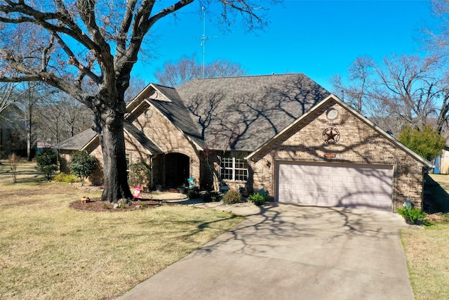 view of front of property featuring a garage and a front yard