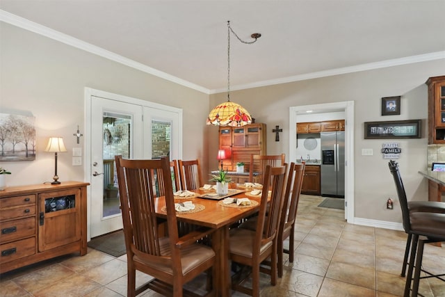 dining area featuring ornamental molding and light tile patterned floors