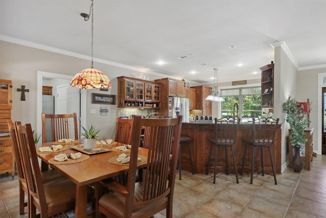 dining room featuring crown molding