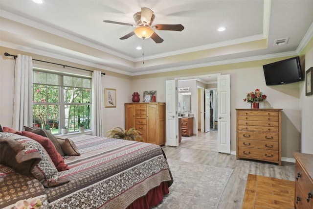 bedroom featuring a raised ceiling, crown molding, ceiling fan, and light hardwood / wood-style floors