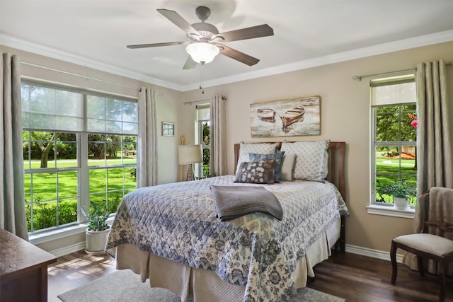 bedroom featuring ceiling fan, ornamental molding, and dark hardwood / wood-style flooring