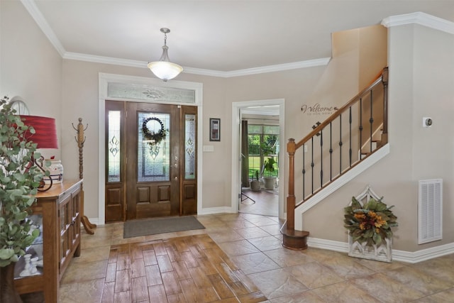 foyer entrance featuring ornamental molding and light hardwood / wood-style floors