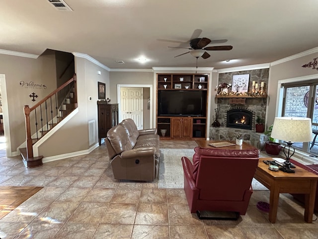 living room with a stone fireplace, ornamental molding, and ceiling fan