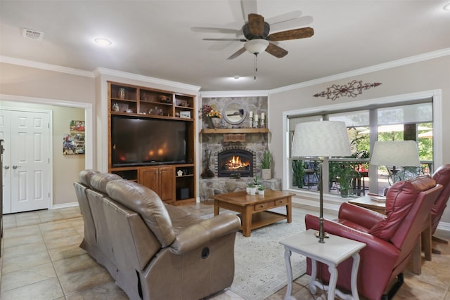 living room featuring ceiling fan, ornamental molding, a fireplace, and light tile patterned floors