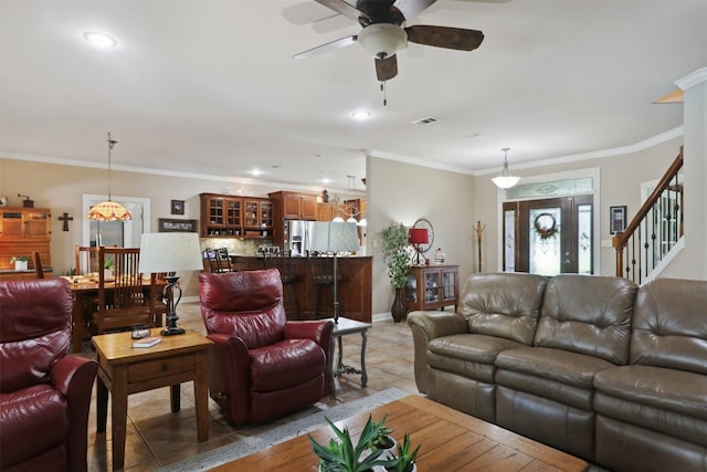 living room featuring crown molding, ceiling fan, and light tile patterned flooring