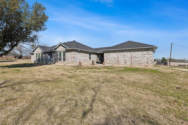 back of house with a lawn