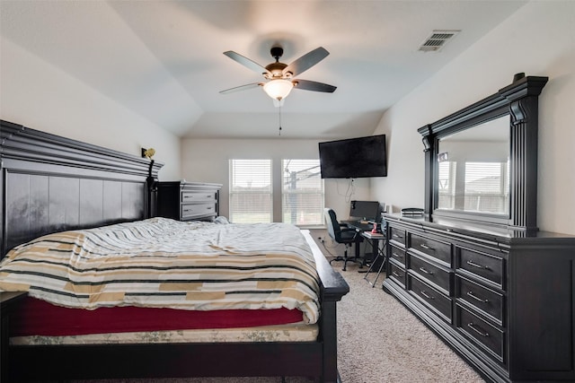 bedroom featuring vaulted ceiling, light colored carpet, and ceiling fan