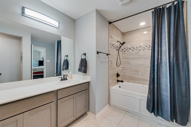 bathroom with shower / bathtub combination with curtain, vanity, and tile patterned flooring