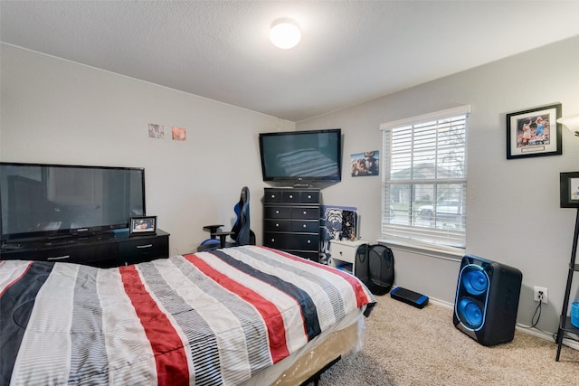 bedroom with lofted ceiling, carpet floors, and a textured ceiling