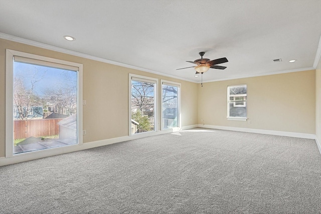 carpeted spare room featuring ceiling fan and ornamental molding