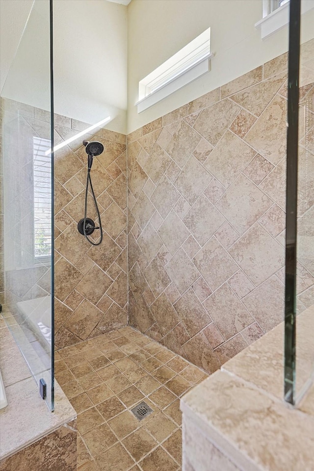 bathroom with a tile shower