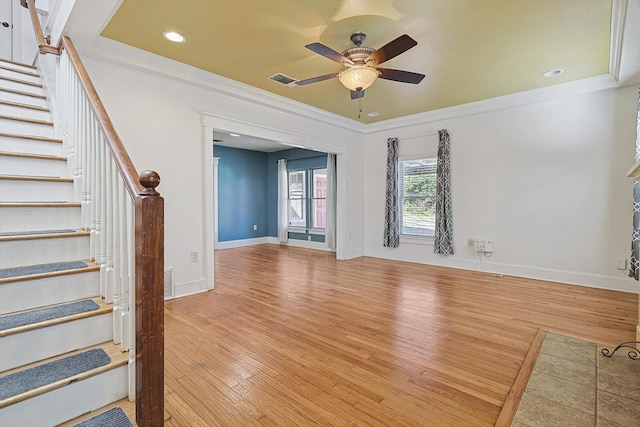 unfurnished living room featuring ornamental molding, ceiling fan, and light hardwood / wood-style floors