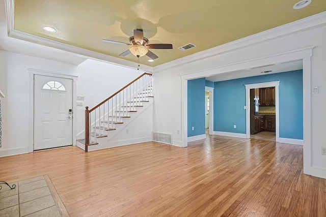 interior space featuring ceiling fan, ornamental molding, and light hardwood / wood-style flooring