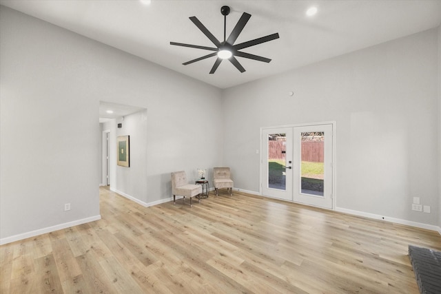 unfurnished room featuring light wood finished floors, ceiling fan, baseboards, and french doors