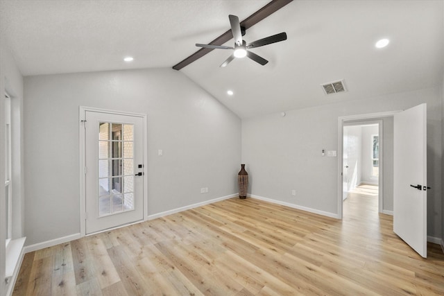 empty room featuring vaulted ceiling with beams, visible vents, a ceiling fan, light wood-type flooring, and baseboards