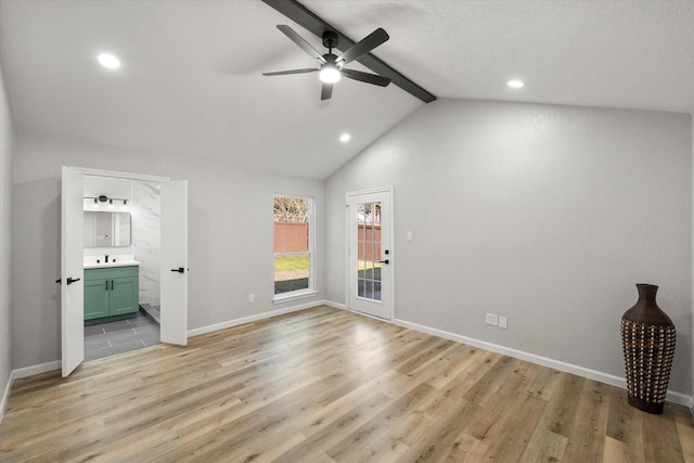 interior space with lofted ceiling with beams, recessed lighting, light wood-style flooring, and baseboards