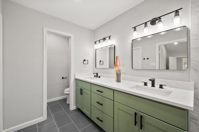 bathroom with tile patterned flooring, a sink, toilet, and double vanity