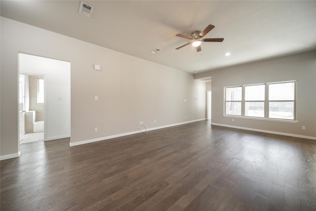 spare room with dark wood-type flooring and ceiling fan