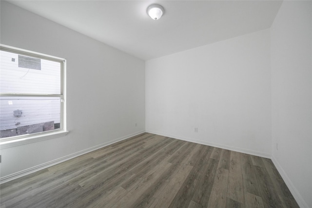 spare room with dark hardwood / wood-style floors