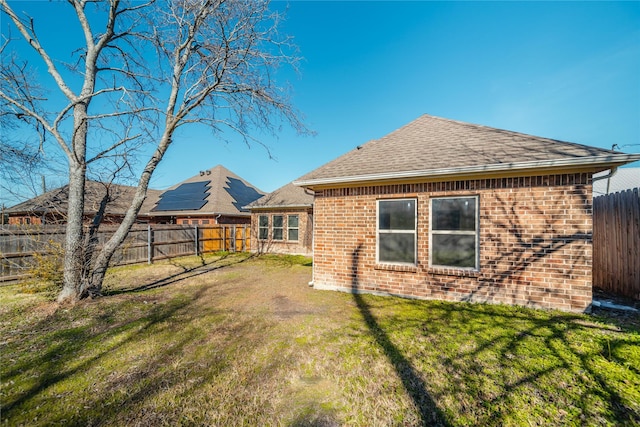 rear view of house with a lawn