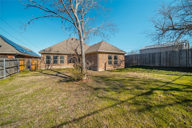 rear view of house featuring a yard