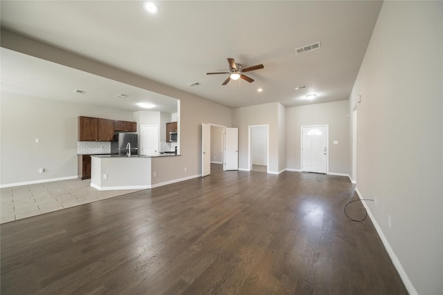 unfurnished living room with hardwood / wood-style floors and ceiling fan