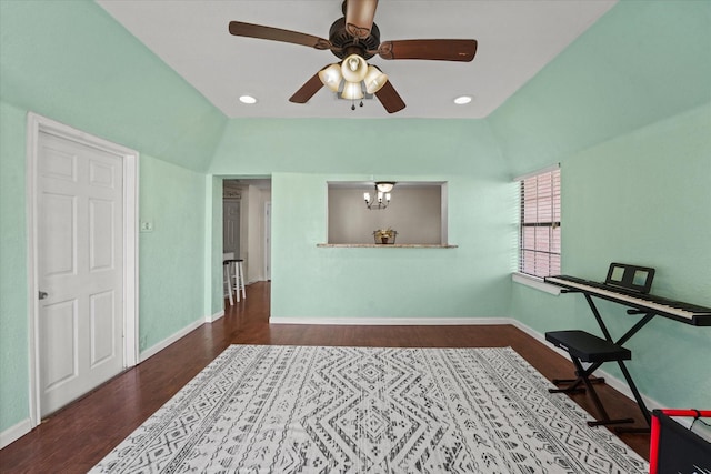 sitting room featuring vaulted ceiling, ceiling fan with notable chandelier, and hardwood / wood-style floors