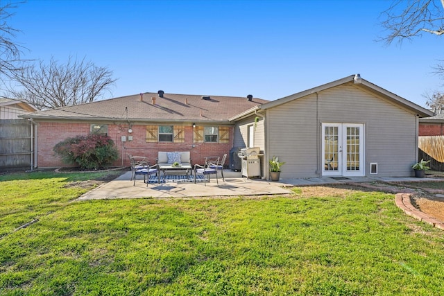 rear view of house featuring french doors, a yard, an outdoor hangout area, and a patio