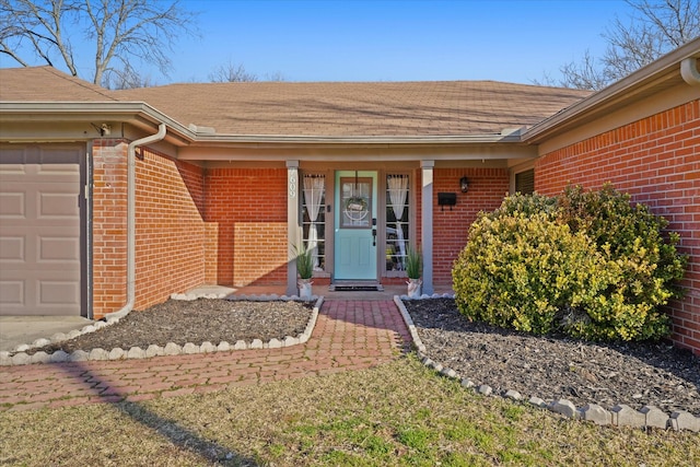 doorway to property with a garage