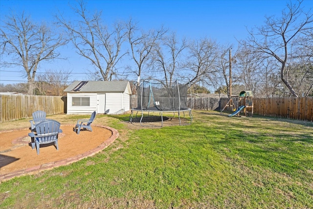 view of yard with a playground, a trampoline, and a shed