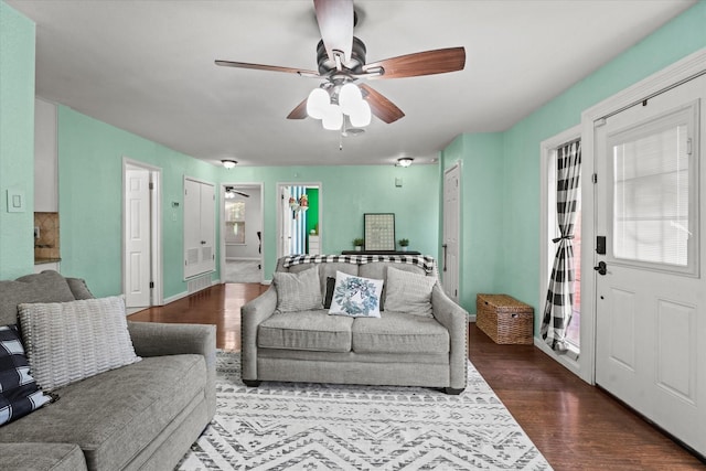 living room with wood-type flooring, plenty of natural light, and ceiling fan