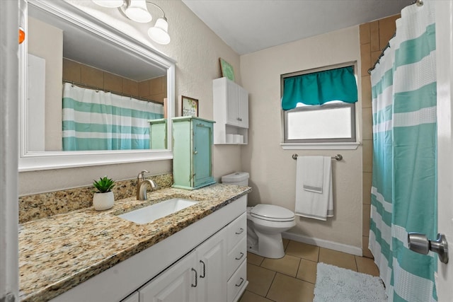 bathroom with vanity, tile patterned floors, toilet, and walk in shower