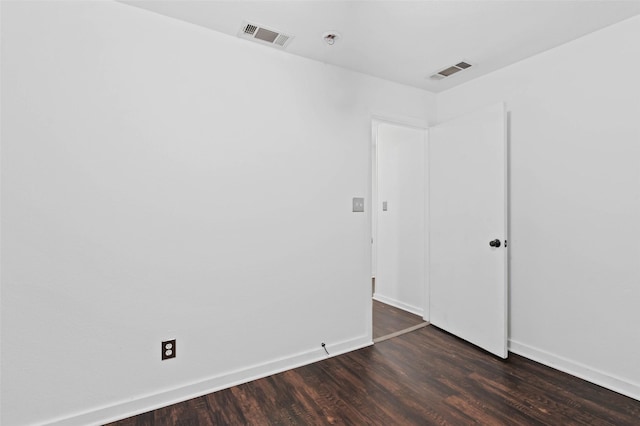 unfurnished room featuring dark hardwood / wood-style flooring