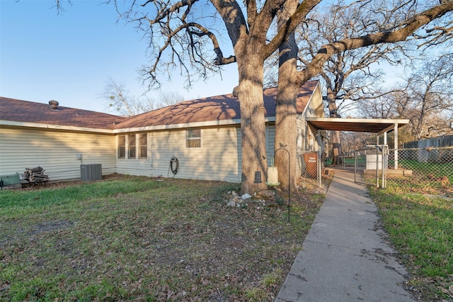 view of side of property featuring cooling unit and a lawn