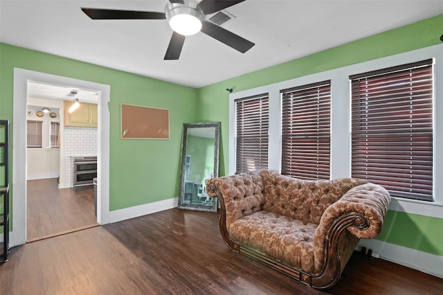 sitting room featuring dark hardwood / wood-style floors and ceiling fan