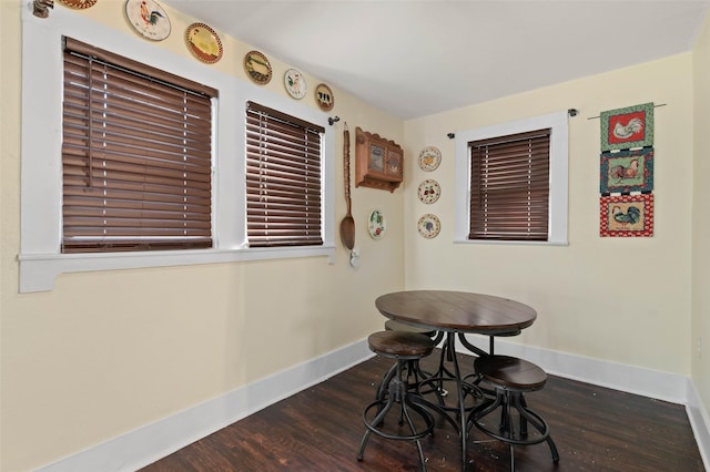 dining space with dark hardwood / wood-style flooring