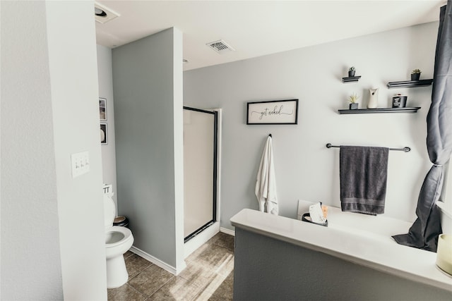 bathroom featuring an enclosed shower, tile patterned floors, and toilet