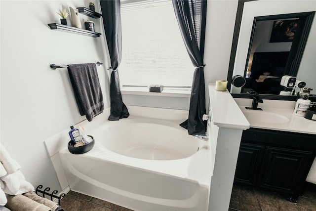 bathroom featuring tile patterned floors, vanity, and a bathing tub