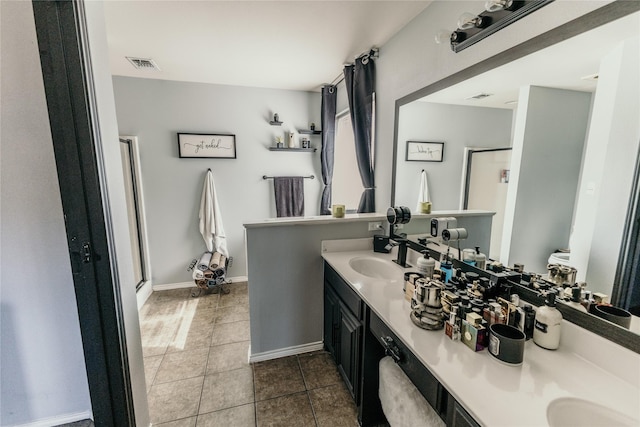 bathroom with vanity, tile patterned floors, and a shower with shower door