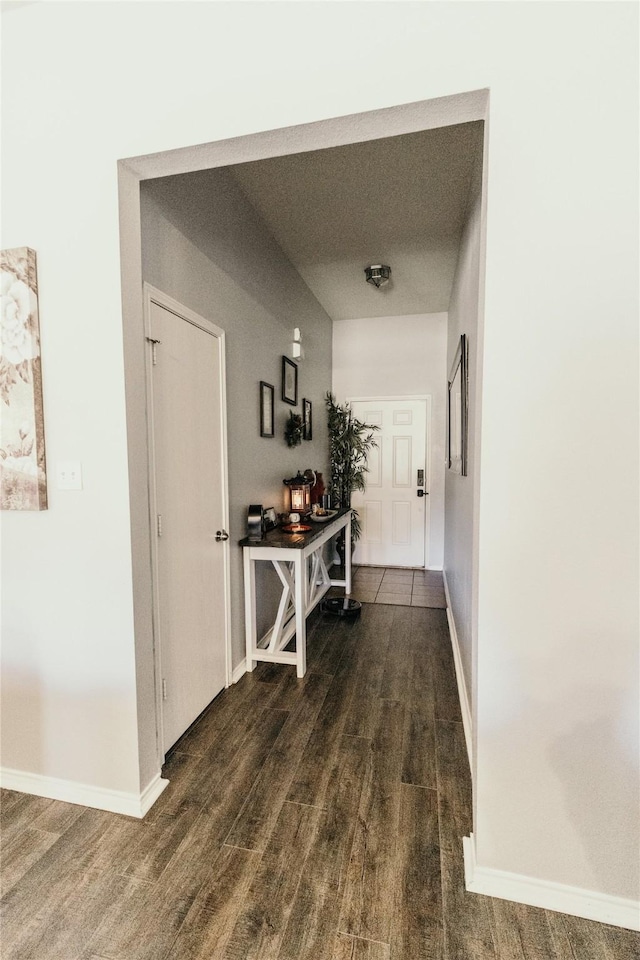 corridor with dark hardwood / wood-style floors