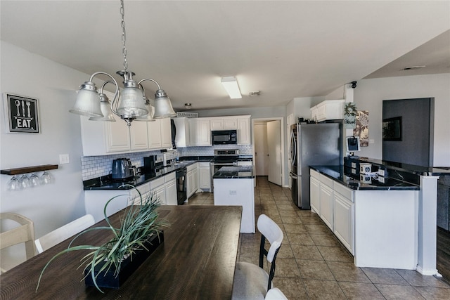 kitchen featuring black appliances, decorative backsplash, white cabinets, dark tile patterned flooring, and decorative light fixtures