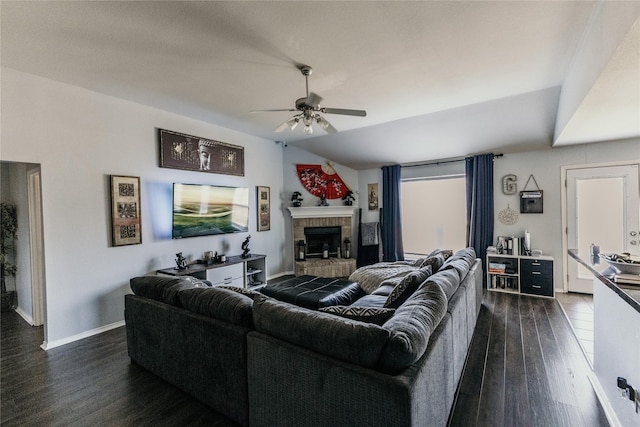 living room featuring lofted ceiling, dark hardwood / wood-style floors, ceiling fan, and a brick fireplace