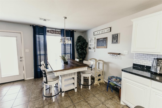 dining area with light tile patterned flooring and a wealth of natural light