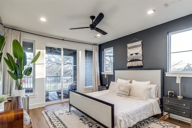 bedroom with access to exterior, hardwood / wood-style flooring, and ceiling fan