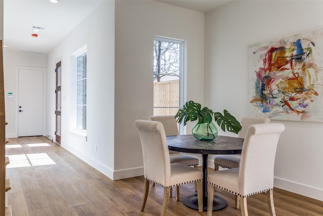 dining room with wood-type flooring