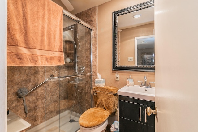 bathroom with vanity, toilet, and a shower with door